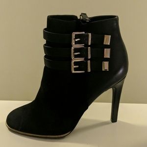 Black heeled booties with buckle details